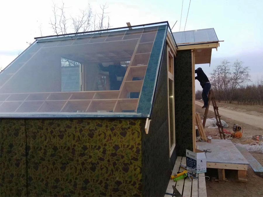 Construction Underway for Light-Filled Small Wooden House with Striking Triangular Roof